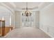 Elegant dining room featuring a tray ceiling, chandelier, and bay window with white shutters at 3690 Millwater Xing, Dacula, GA 30019