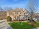 Beautiful two-story brick home with a well-manicured lawn and a large driveway on a sunny day at 3690 Millwater Xing, Dacula, GA 30019