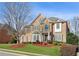 Charming brick home with manicured landscaping, lush green lawn and mature trees creating curb appeal at 3690 Millwater Xing, Dacula, GA 30019