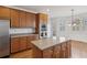 Bright kitchen with stainless steel appliances, center island with wooden cabinets, and hardwood flooring at 3690 Millwater Xing, Dacula, GA 30019