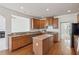 Spacious kitchen featuring an island, wooden cabinetry, granite countertops and stainless steel appliances at 3690 Millwater Xing, Dacula, GA 30019