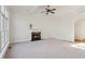 Bright, spacious living room with fireplace, large windows with backyard views, and a ceiling fan at 3690 Millwater Xing, Dacula, GA 30019