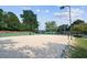 Well-maintained sand volleyball court on a sunny day is steps from a playground at 3690 Millwater Xing, Dacula, GA 30019