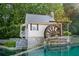 Water wheel house feature with tranquil water and lush landscaping, a delightful community focal point at 3690 Millwater Xing, Dacula, GA 30019