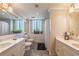 This bathroom is well-lit and features dual vanities with marble countertops and a shower/tub combo at 75 14Th Ne St # 3160, Atlanta, GA 30309