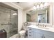 Bright bathroom with large mirror, marble countertops, marble walk in shower and tiled floors at 75 14Th Ne St # 3160, Atlanta, GA 30309