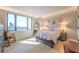 This bedroom has floor to ceiling windows, hardwood floors, and neutral colored decor at 75 14Th Ne St # 3160, Atlanta, GA 30309