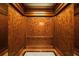 Luxurious elevator features wood-paneled walls, a marble floor border, and brushed metal handrail at 75 14Th Ne St # 3160, Atlanta, GA 30309
