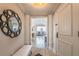 Inviting entryway with a decorative mirror, bench, and views of a city skyline from the interior at 75 14Th Ne St # 3160, Atlanta, GA 30309