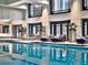 Indoor lap pool featuring lounge seating, tall windows, and decorative plants at 75 14Th Ne St # 3160, Atlanta, GA 30309