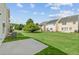 Spacious backyard with well-maintained lawn and concrete patio at 150 Chandler Trace, Covington, GA 30016