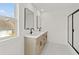Dual vanity bathroom featuring contemporary fixtures, framed mirrors and large window at 150 Chandler Trace, Covington, GA 30016