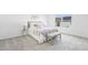 Neutral carpeted bedroom with large window and decoratively staged bed and bench at 150 Chandler Trace, Covington, GA 30016
