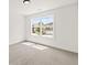 Bright, carpeted bedroom with a large window offering a view of the neighborhood at 150 Chandler Trace, Covington, GA 30016