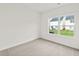 Cozy bedroom with neutral carpet, large window with view of the backyard at 150 Chandler Trace, Covington, GA 30016