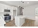 Bright, modern kitchen with stainless steel appliances, a center island, and sleek finishes at 150 Chandler Trace, Covington, GA 30016