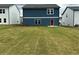 Home with a large grassy backyard and a blue exterior with a red door at , Conyers, GA 30094