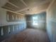 Bedroom featuring newly installed drywall, large window, and ceiling details at , Conyers, GA 30094