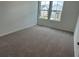 Bright bedroom featuring two windows, neutral walls, and plush carpeting at , Conyers, GA 30094