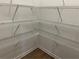 Walk-in closet featuring white shelving for ample storage and wood-look flooring at , Conyers, GA 30094