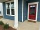 Close up of the red front door with sidelight and white trim, accenting the blue exterior at , Conyers, GA 30094