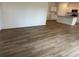 Open-concept living area with wood-look flooring, leading to the kitchen with granite countertops at , Conyers, GA 30094