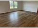 Spacious living room showcasing wood-look flooring and windows for natural light at , Conyers, GA 30094
