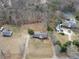 Aerial view of a single-Gathering home, including mature trees, a tennis court, and surrounding neighborhood at 1560 Sever Rd, Lawrenceville, GA 30043