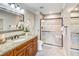 Modern bathroom featuring a tiled walk-in shower, granite countertops, and a spacious vanity area at 300 Johnson Ferry Ne Rd # A712, Atlanta, GA 30328