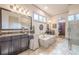 Luxurious bathroom features a soaking tub, walk-in shower, and double vanity sinks at 4880 Cecilia Sq, Cumming, GA 30040