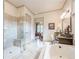 Bright bathroom features a stand alone shower and bath in a neutral color scheme at 4880 Cecilia Sq, Cumming, GA 30040