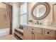 Bright bathroom featuring a vanity with natural light, storage, and a shower-tub combination at 4880 Cecilia Sq, Cumming, GA 30040