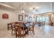 Spacious game room with a shuffleboard table, decorative lighting, and a dining area with lots of natural light at 4880 Cecilia Sq, Cumming, GA 30040