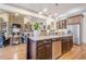 Kitchen featuring stone backsplash, granite counters, stainless appliances, and an open view to the living area at 4880 Cecilia Sq, Cumming, GA 30040
