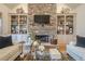 Cozy living room with stone fireplace, built-in shelving, and neutral decor at 4880 Cecilia Sq, Cumming, GA 30040