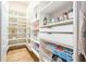Walk-in pantry with custom shelving for organized storage at 4880 Cecilia Sq, Cumming, GA 30040