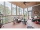 Relaxing screened porch with ceiling fan, comfortable seating, and natural light at 4880 Cecilia Sq, Cumming, GA 30040
