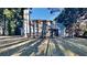 View of the back of this two-story home, with a large deck and ample backyard space surrounded by mature trees at 3075 Elizabeth Ln, Snellville, GA 30078