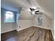 Bedroom featuring a vaulted ceiling, modern fan, hard wood floors, and a large arched window with backyard views at 3075 Elizabeth Ln, Snellville, GA 30078