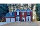 Charming red brick two-story home with manicured lawn and attached two car garage at 3075 Elizabeth Ln, Snellville, GA 30078