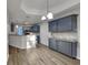 Kitchen with granite countertops, tile backsplash, stainless steel appliances, and gray cabinetry at 3075 Elizabeth Ln, Snellville, GA 30078