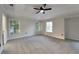 Spacious main bedroom with a tray ceiling, ceiling fan, neutral walls, and natural light from the double-hung windows at 3075 Elizabeth Ln, Snellville, GA 30078