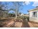 A backyard featuring a classic home with large trees, an outdoor dining area, and a well-manicured lawn at 4951 Center Hill Church Rd, Loganville, GA 30052