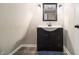 Bathroom featuring a vanity with undermount sink, stylish lighting, and tile flooring at 4951 Center Hill Church Rd, Loganville, GA 30052