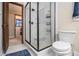 Bathroom featuring a walk-in shower with black trim, toilet, and door to adjacent room at 4951 Center Hill Church Rd, Loganville, GA 30052
