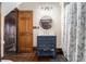 Traditional bathroom features a blue vanity, round mirror, and tub-shower with floral curtains at 4951 Center Hill Church Rd, Loganville, GA 30052