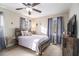 Bedroom featuring a wooden bed frame, ceiling fan and natural light from the windows at 4951 Center Hill Church Rd, Loganville, GA 30052