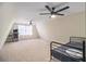 Spacious bedroom featuring neutral carpet, modern ceiling fans, and a charming sloped ceiling at 4951 Center Hill Church Rd, Loganville, GA 30052
