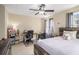 Bright bedroom features a ceiling fan, study area, and natural light from a side window at 4951 Center Hill Church Rd, Loganville, GA 30052