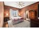 Bedroom features wood paneled walls and ceiling fan, with a window view and closet at 4951 Center Hill Church Rd, Loganville, GA 30052